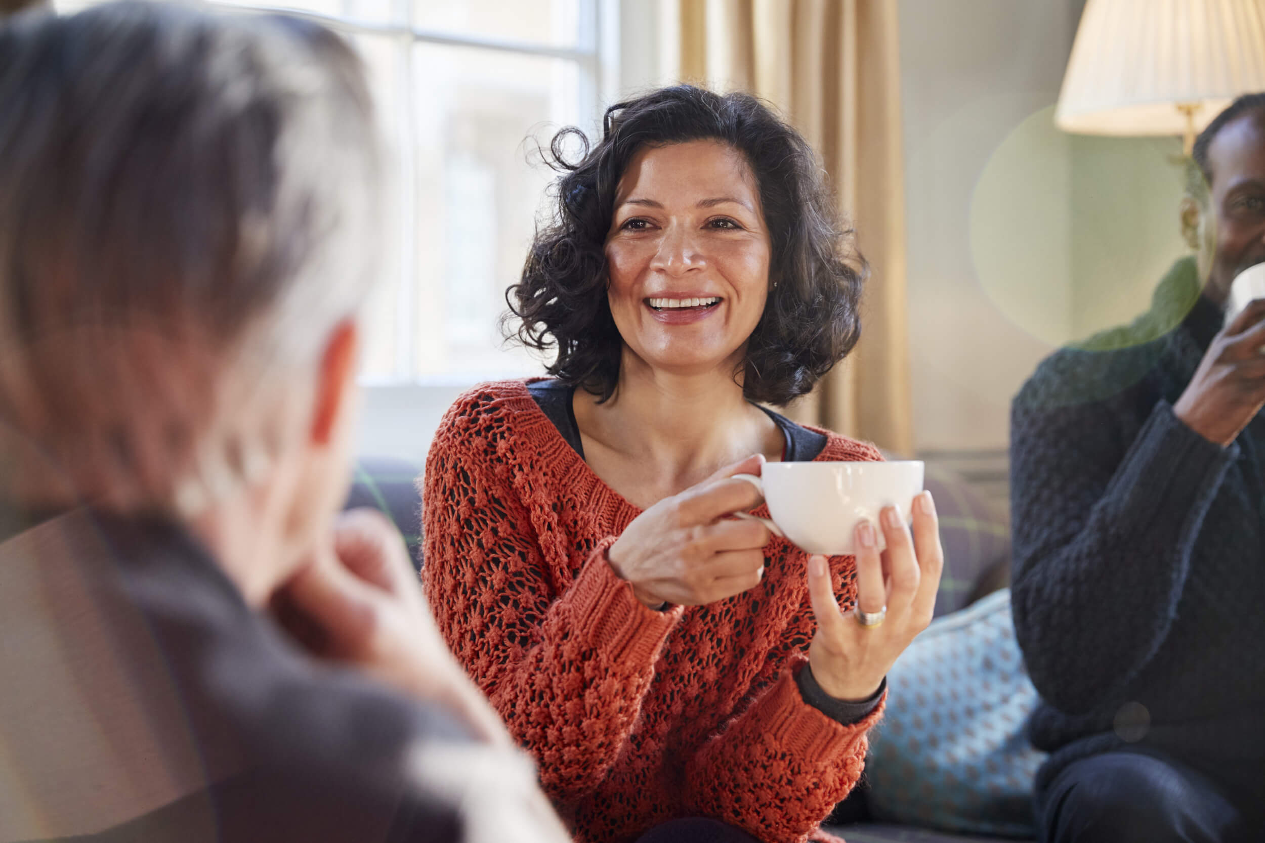 smiling woman holding a cup of coffee