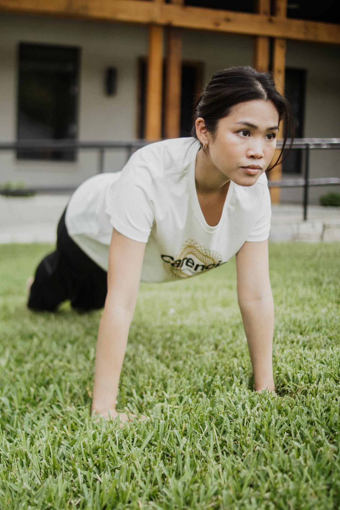 woman doing a plank wearing carencia shirt