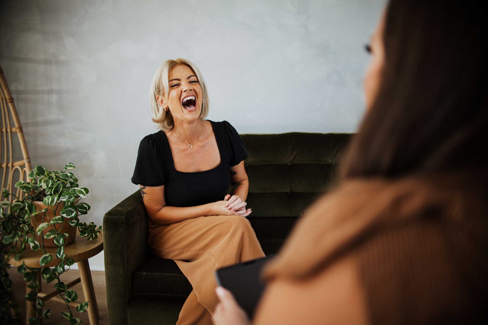 a woman laughing uncontrollably